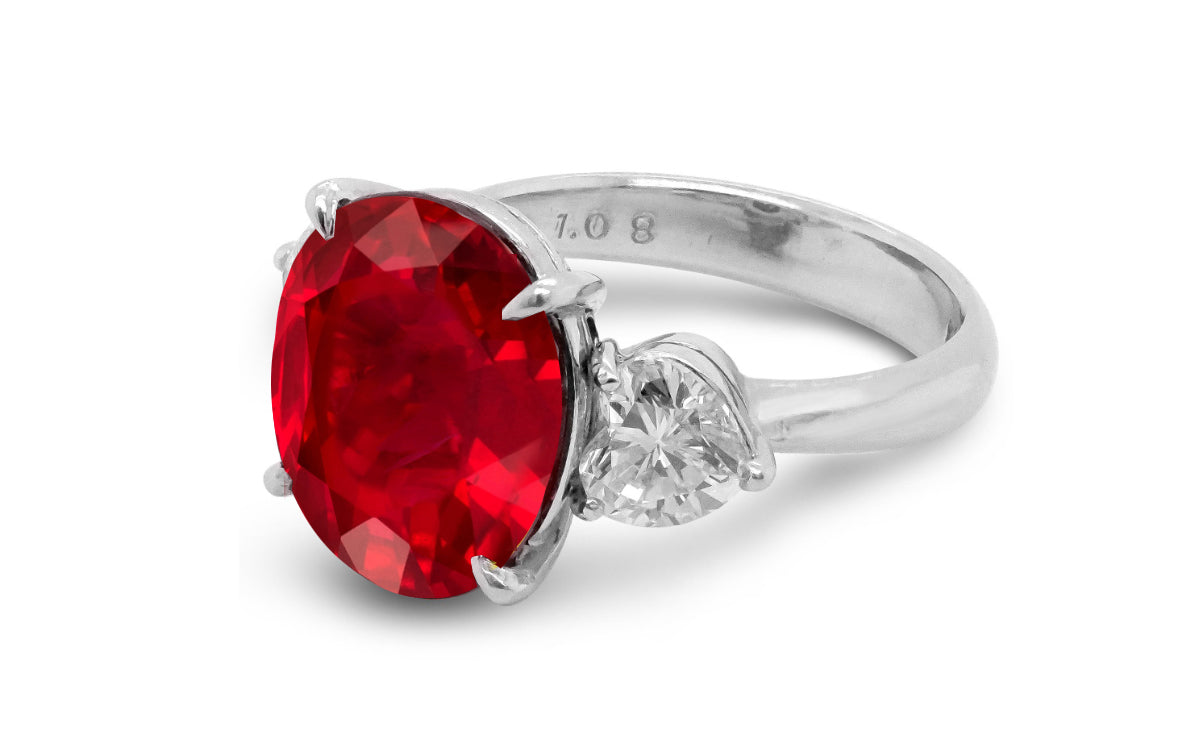 209 custom made unique oval cut ruby center stone and heart diamond side three stone engagement ring