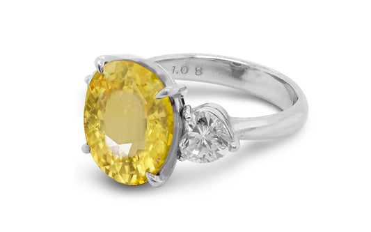 209 custom made unique oval cut yellow sapphire center stone and heart diamond side three stone engagement ring