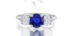 211 custom made unique round cut blue sapphire center stone and round diamond side three stone engagement ring