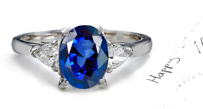 engagement ring three stone with oval blue sapphire and side pear diamonds