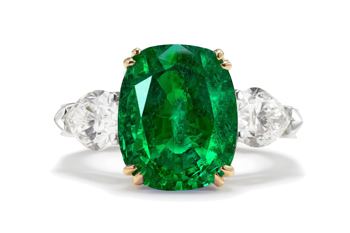 217 custom made unique oval emerald center stone and pear diamond side three stone engagement ring