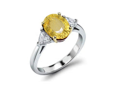 218 custom made unique oval yellow sapphire center stone and trillion diamond side three stone engagement ring