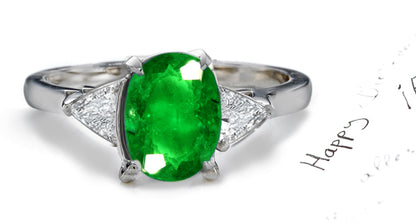 engagement ring three stone with oval emerald and side trillion diamonds