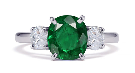 231 custom made unique oval emerald center stone and round diamond side three stone engagement ring