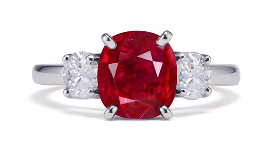 231 custom made unique oval ruby center stone and round diamond side three stone engagement ring