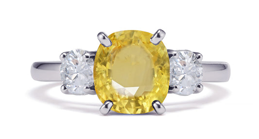 231 custom made unique oval yellow sapphire center stone and round diamond side three stone engagement ring