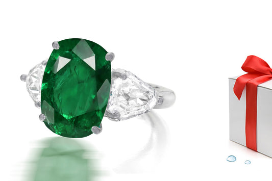 232 custom made unique oval emerald center stone and fanct diamond side three stone engagement ring