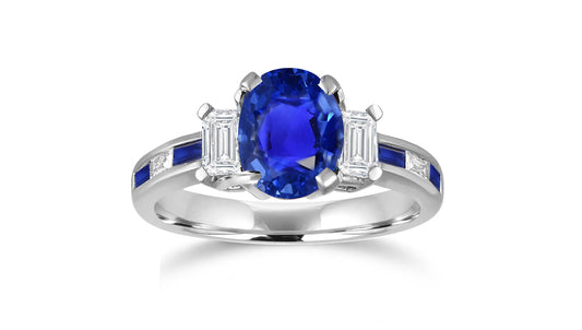 240 custom made unique oval blue sapphire center stone and baguette blue sapphire diamond side engagement ring