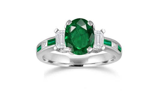 240 custom made unique oval emerald center stone and baguette emerald diamond side engagement ring