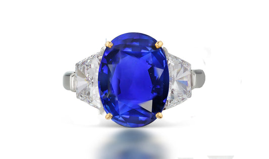 266 custom made unique oval blue sapphire center stone and trapezoid diamond accent three stone engagement ring