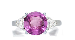 276 custom made unique round pink sapphire center stone and heart diamond accent three stone engagement ring