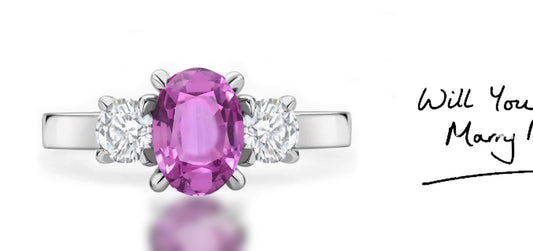 286 custom made unique oval pink sapphire center stone and round diamond accent three stone engagement ring