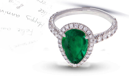 29 custom made unique pear emerald center stone with diamond halo and side diamond accents engagement ring