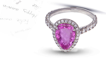 29 custom made unique pear pink sapphire center stone with diamond halo and side diamond accents engagement ring