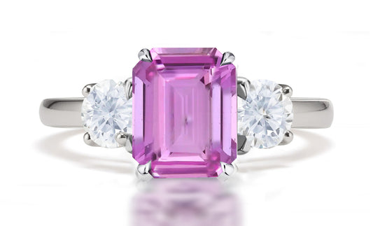 290 custom made unique emerald cut pink sapphire center stone and round diamond accent three stone engagement ring