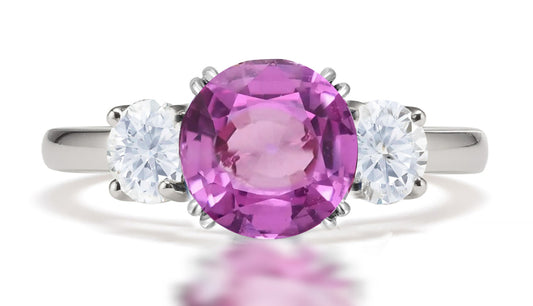 292 custom made unique round pink sapphire center stone and round diamond accent three stone engagement ring