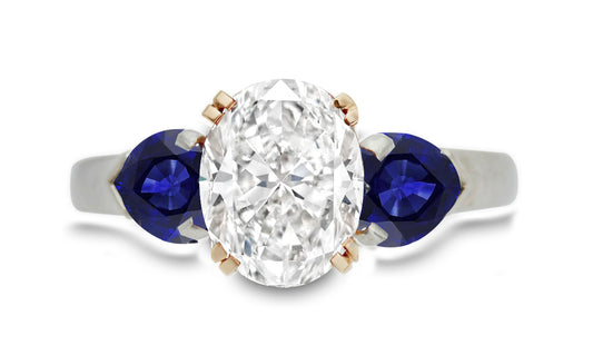 299 custom made unique oval diamond center stone and heart blue sapphire accent three stone engagement ring