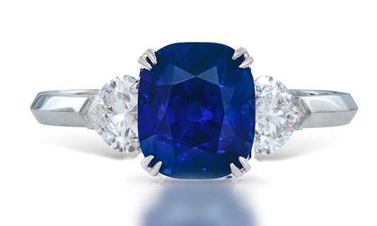 3 custom made unique cushion cut blue sapphire center stone with heart diamond accents three stone engagement ring