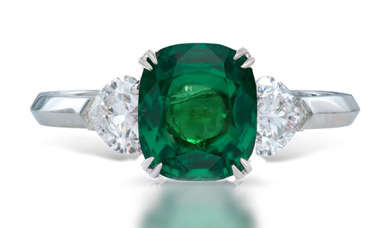 3 custom made unique cushion cut emerald center stone with heart diamond accents three stone engagement ring