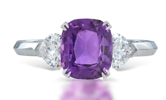 3 custom made unique cushion cut purple sapphire center stone with heart diamond accents three stone engagement ring