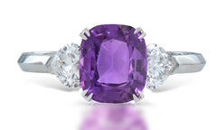 3 custom made unique cushion cut purple sapphire center stone with heart diamond accents three stone engagement ring