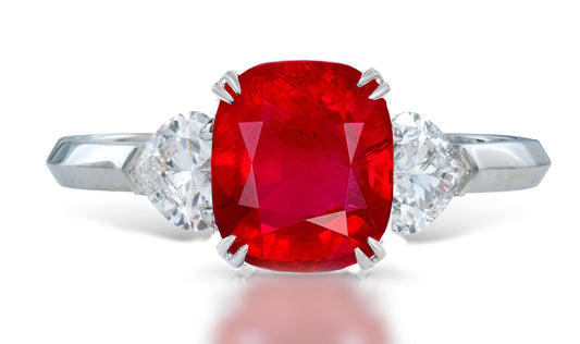 3 custom made unique cushion cut ruby center stone with heart diamond accents three stone engagement ring