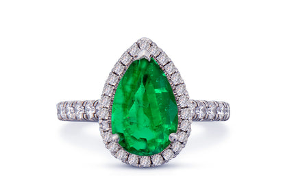 29 custom made unique pear emerald center stone with diamond halo and side diamond accents engagement ring