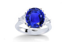 304 custom made unique oval blue sapphire center stone and trillion diamond accent three stone engagement ring