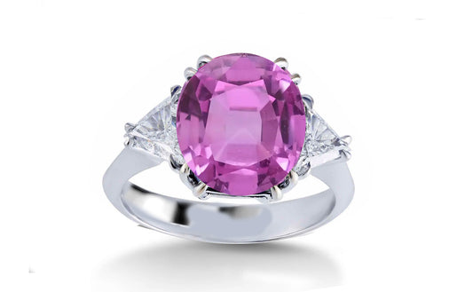 304 custom made unique oval pink sapphire center stone and trillion diamond accent three stone engagement ring