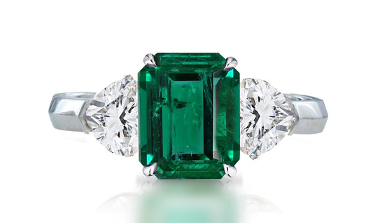 32 custom made unique emerald cut emerald center stone with heart diamond accents three stone engagement ring