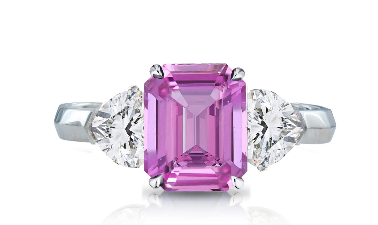 32 custom made unique emerald cut pink sapphire center stone with heart diamond accents three stone engagement ring