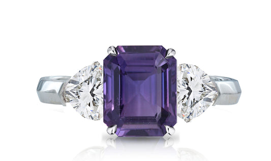 32 custom made unique emerald cut purple sapphire center stone with heart diamond accents three stone engagement ring