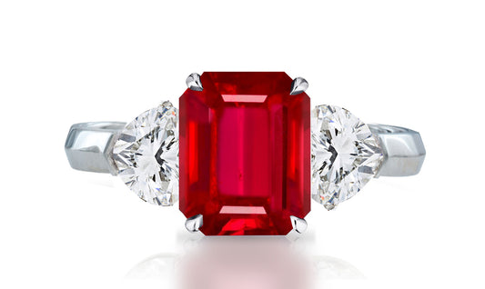 32 custom made unique emerald cut ruby center stone with heart diamond accents three stone engagement ring