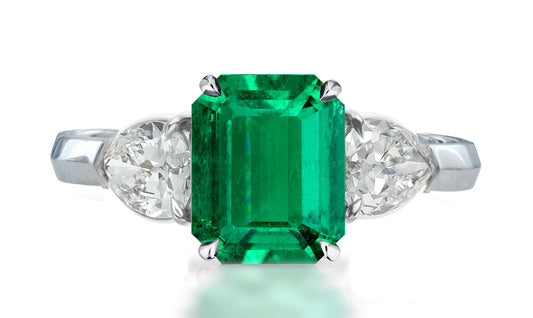 33 custom made unique emerald cut emerald center stone with pear diamond accents three stone engagement ring