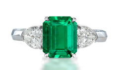 33 custom made unique emerald cut emerald center stone with pear diamond accents three stone engagement ring