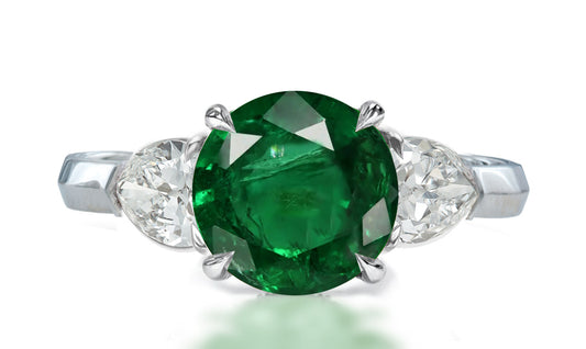 35 custom made unique round emerald center stone with pear diamond accents three stone engagement ring