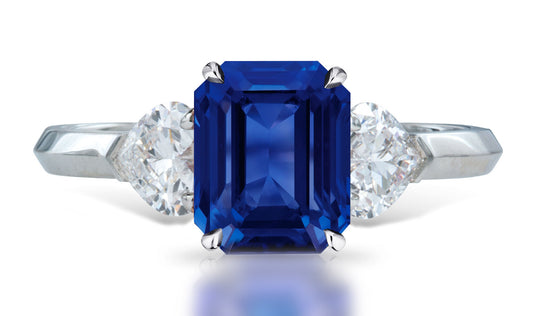 4 custom made unique emerald cut blue sapphire center stone with heart diamond accents three stone engagement ring