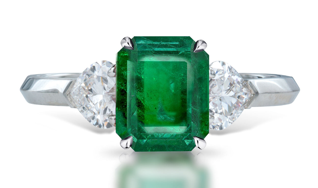 4 custom made unique emerald cut emerald center stone with heart diamond accents three stone engagement ring