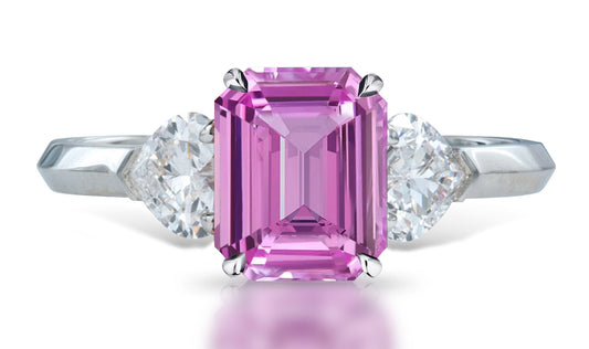 4 custom made unique emerald cut pink sapphire center stone with heart diamond accents three stone engagement ring