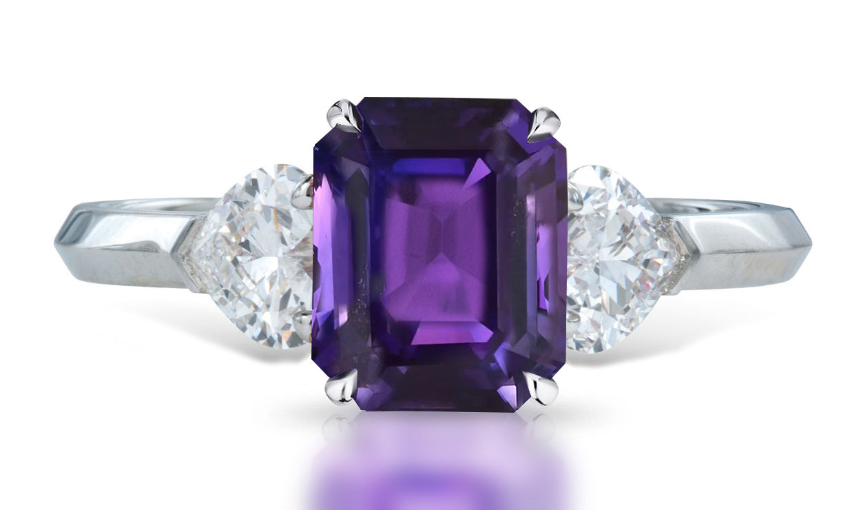 4 custom made unique emerald cut purple sapphire center stone with heart diamond accents three stone engagement ring