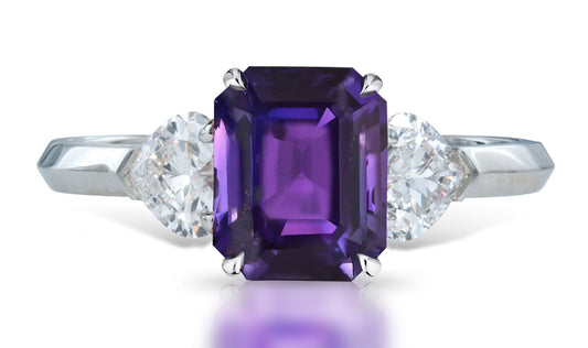 4 custom made unique emerald cut purple sapphire center stone with heart diamond accents three stone engagement ring