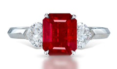 4 custom made unique emerald cut ruby center stone with heart diamond accents three stone engagement ring