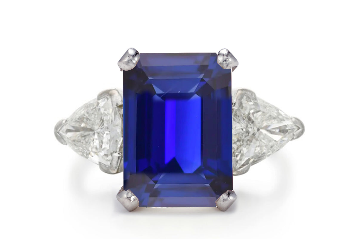 400 custom made unique emerald cut blue sapphire center stone and trillion diamond accents three stone engagement ring