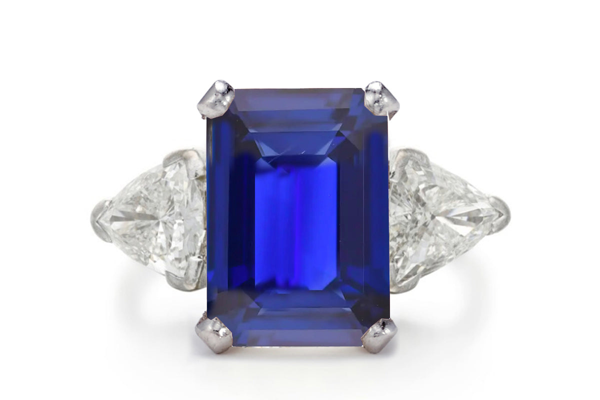 500 custom made unique emerald cut blue sapphire center stone and trillion diamond accents three stone engagement ring