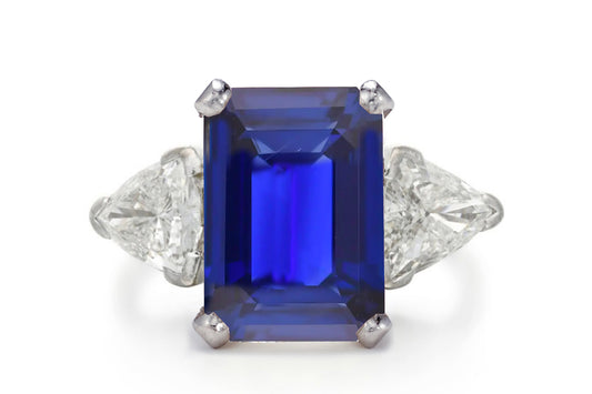 500 custom made unique emerald cut blue sapphire center stone and trillion diamond accents three stone engagement ring