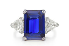 500 custom made unique emerald cut blue sapphire center stone and trillion diamond accents three stone engagement ring