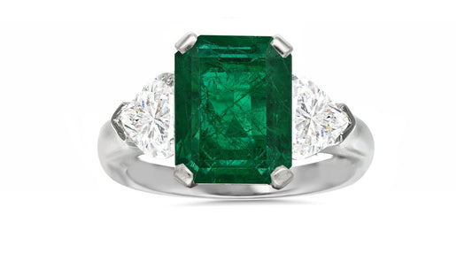 127 custom made unique emerald cut emerald center stone and heart diamond side three stone engagement ring