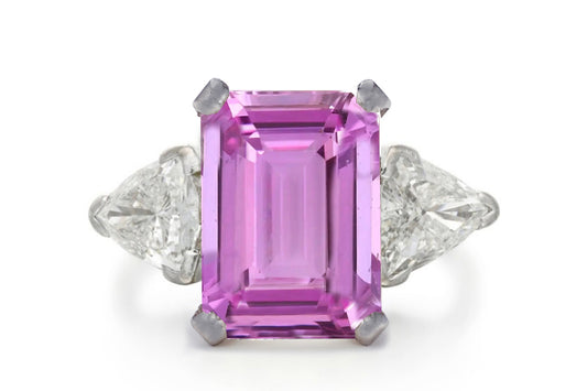 500 custom made unique emerald cut pink sapphire center stone and trillion diamond accents three stone engagement ring