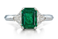 515 custom made unique emerald cut emerald center stone and trillion diamond accent three stone engagement ring