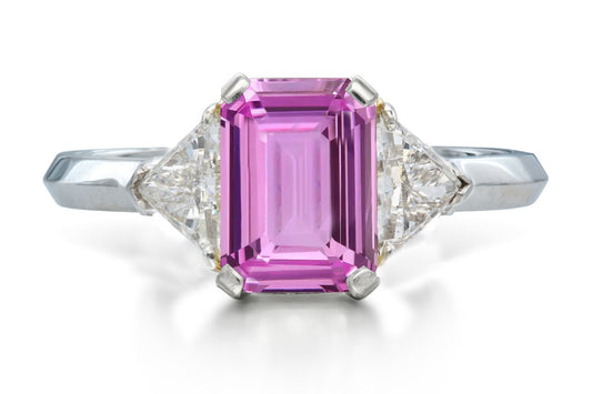 515 custom made unique emerald cut pink sapphire center stone and trillion diamond accent three stone engagement ring